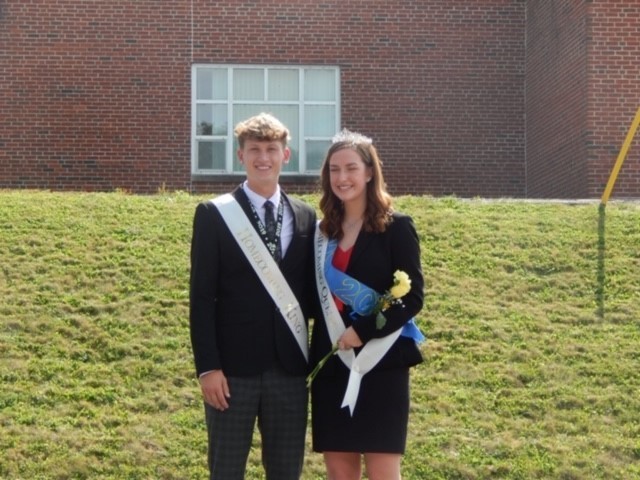 Homecoming King and Queen in front of a building 