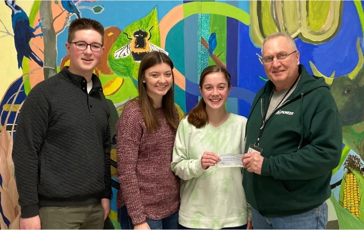 Nathan Lesh, Riley Danko and Emily Clark accepted. donation to the FFA for the meal packing event from Billy Lyons who is a member of the Three Springs Church in Blain  