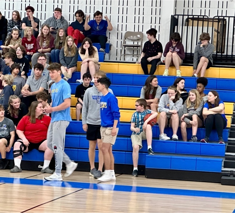 Senior varsity basketball players award peer with a signed basketball